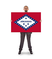 Image showing Smiling businessman holding a big card, flag of Arkansas