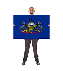 Image showing Smiling businessman holding a big card, flag of Pennsylvania