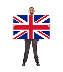 Image showing Smiling businessman holding a big card, flag of the United Kingd