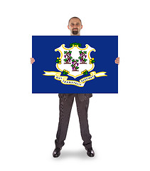 Image showing Smiling businessman holding a big card, flag of Connecticut