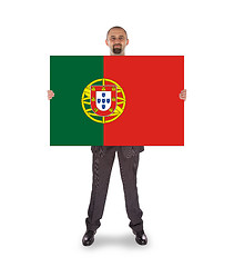 Image showing Smiling businessman holding a big card, flag of Portugal