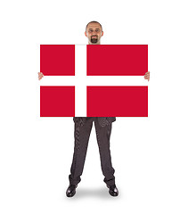 Image showing Smiling businessman holding a big card, flag of Denmark