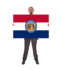 Image showing Smiling businessman holding a big card, flag of Missouri