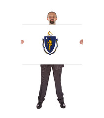 Image showing Smiling businessman holding a big card, flag of Massachusetts