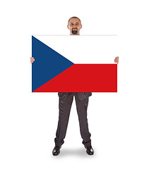 Image showing Smiling businessman holding a big card, flag of the Czech Republ