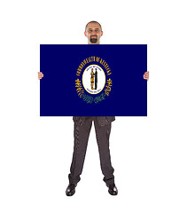 Image showing Smiling businessman holding a big card, flag of Kentucky