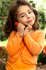 Image showing Beautiful little girl holding a flower picked from the garden