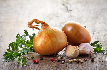 Image showing onions and garlic on a wooden table