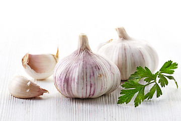 Image showing garlic and parsley on a white wooden table