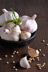 Image showing Garlic and white pepper on brown wooden table