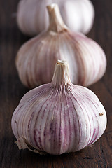 Image showing Garlic on a brown wooden table
