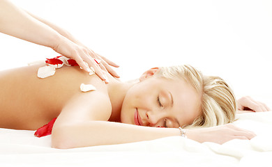 Image showing professional massage with flower petals