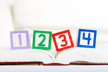 Image showing Alphabet block with 1234 on opened book