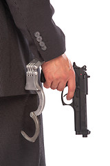 Image showing Businessman with gun and handcuffs