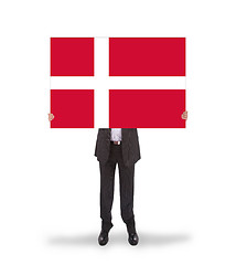 Image showing Smiling businessman holding a big card, flag of Denmark