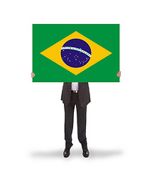 Image showing Smiling businessman holding a big card, flag of Brazil