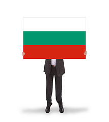 Image showing Smiling businessman holding a big card, flag of Bulgaria