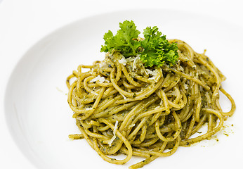 Image showing Italian pasta spaghetti with pesto sauce and basil leaf 