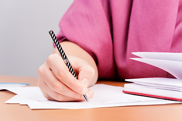 Image showing Woman writing in organizer