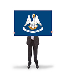 Image showing Smiling businessman holding a big card, flag of Louisiana