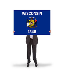Image showing Smiling businessman holding a big card, flag of Wisconsin