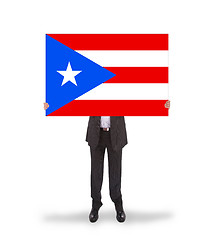 Image showing Smiling businessman holding a big card, flag of Puerto Rico