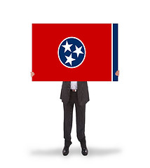 Image showing Smiling businessman holding a big card, flag of Tennessee