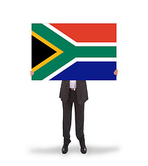 Image showing Smiling businessman holding a big card, flag of South Africa