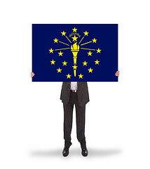 Image showing Smiling businessman holding a big card, flag of Indiana