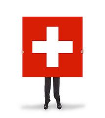 Image showing Smiling businessman holding a big card, flag of Switzerland