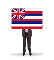 Image showing Smiling businessman holding a big card, flag of Hawaii