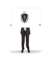 Image showing Smiling businessman holding a big card, flag of Massachusetts