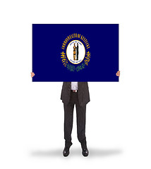 Image showing Smiling businessman holding a big card, flag of Kentucky