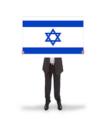 Image showing Smiling businessman holding a big card, flag of Israel