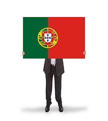 Image showing Smiling businessman holding a big card, flag of Portugal
