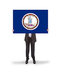 Image showing Smiling businessman holding a big card, flag of Virginia