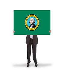 Image showing Smiling businessman holding a big card, flag of Washington