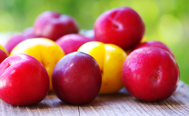 Image showing Ripe plums on wooden table