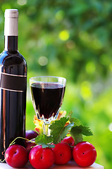 Image showing 	Bottle of red wine and ripe fruits
