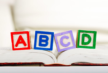 Image showing Alphabet block with ABCD on book 