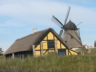 Image showing Windmill and house with straw roof