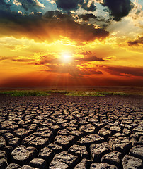 Image showing dramatic sunset over drought land