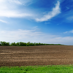 Image showing black spring field and cloudy sky