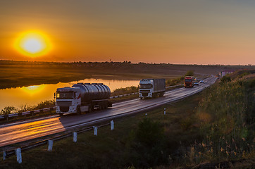 Image showing sunset over road with autos