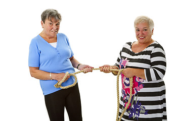 Image showing Two female seniors pulling on a rope