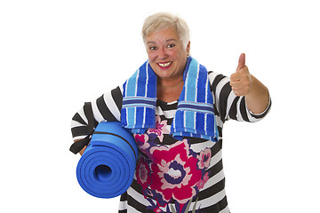 Image showing Female senior with blue gym mat 