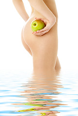 Image showing naked woman with green apple in water