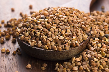 Image showing Buckwheat seeds on wooden spoon in closeup 