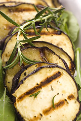 Image showing Grilled eggplant slices on a plate with fresh rosemary