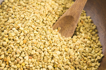 Image showing Bee pollen in wooden scoop. Nutritional supplement